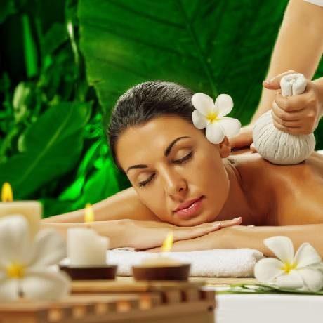 A lady getting a body massage done with Massage Oils at A Spa Centre.